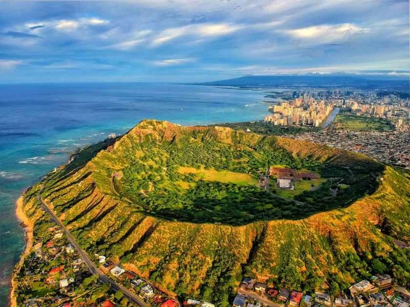 Aerial view of Diamond Head crater with Waikiki behind it