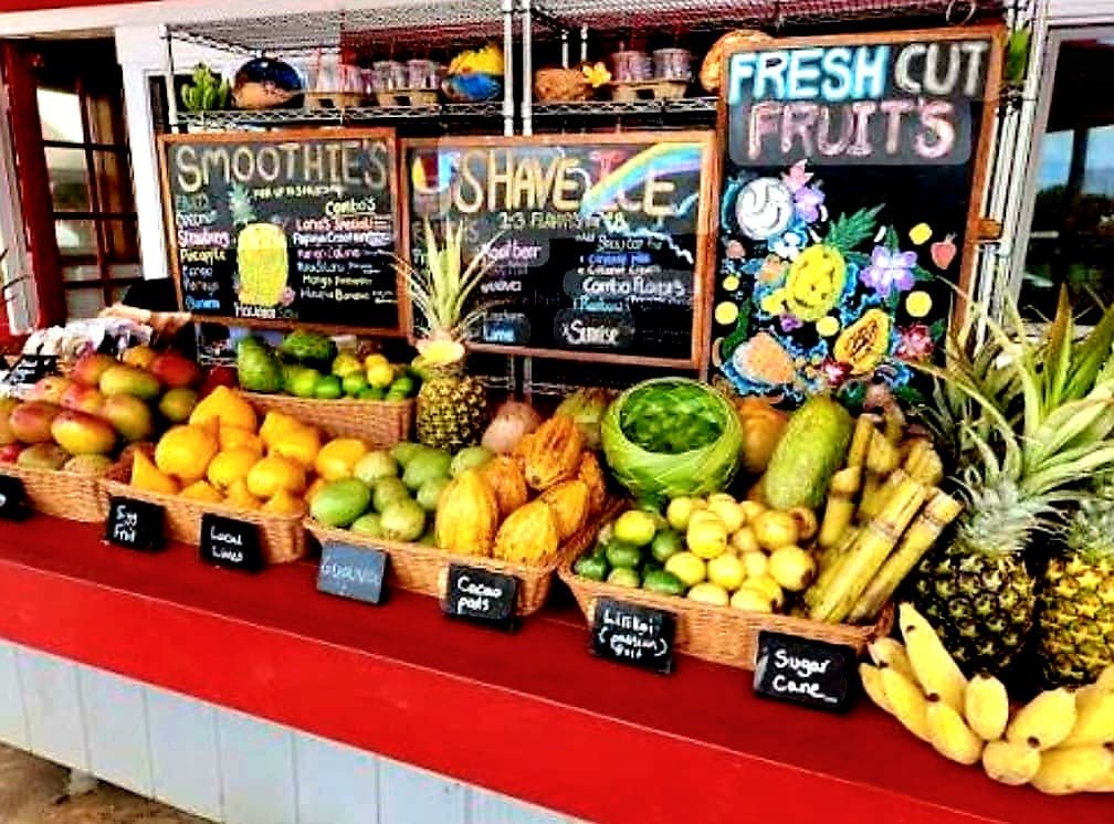 A North Shore roadside stand piled with pineapple, lilikoi, sugar cane and mango